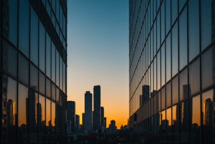 Urban Sunset: Skyscrapers Reflected in Glass Facades at Twilight